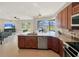 Spacious kitchen open to living area with granite counters, stainless appliances, and lake views at 6132 Waterfield Way, St Cloud, FL 34771