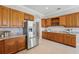 Stylish kitchen features stainless steel refrigerator, granite counters, and sleek backsplash at 6132 Waterfield Way, St Cloud, FL 34771