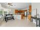 Open concept kitchen with stainless appliances, granite counters, breakfast bar and adjacent dining area at 6132 Waterfield Way, St Cloud, FL 34771