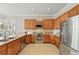 Modern kitchen boasts stainless steel appliances, granite countertops, and ample cabinet space at 6132 Waterfield Way, St Cloud, FL 34771