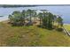 Aerial view of lakefront land featuring mature trees and access to a waterway at 6132 Waterfield Way, St Cloud, FL 34771