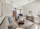 Spacious living room featuring an open floor plan, stylish furniture and views of the dining room at 6132 Waterfield Way, St Cloud, FL 34771