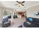Open concept living space with kitchen, breakfast nook, and views to the outdoor pool and lanai at 6132 Waterfield Way, St Cloud, FL 34771