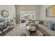 Comfortable living room with a modern couch and sliding glass doors to outside at 6132 Waterfield Way, St Cloud, FL 34771