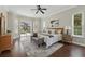 Bright main bedroom featuring a sitting area, wood floors, and access to a screened lanai at 6132 Waterfield Way, St Cloud, FL 34771