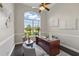 Bright office features large window, ceiling fan, and modern decor for a comfortable work environment at 6132 Waterfield Way, St Cloud, FL 34771
