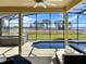 Screened-in pool and hot tub overlook the grassy lawn that extends to the lake at 6132 Waterfield Way, St Cloud, FL 34771
