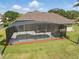 Aerial view of backyard with screened pool, patio and verdant landscaping at 6132 Waterfield Way, St Cloud, FL 34771