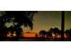 Scenic lake view at sunset with silhouetted trees creating a serene backdrop at 6132 Waterfield Way, St Cloud, FL 34771