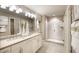 Bright bathroom features a double sink vanity and a glass shower enclosure at 614 Heritage Square Dr, Haines City, FL 33844