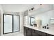 Modern bathroom features double vanity, large mirror, and a glass-enclosed shower at 614 Heritage Square Dr, Haines City, FL 33844