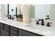 Bathroom vanity features dual sinks with black faucets and a large decorative mirror at 614 Heritage Square Dr, Haines City, FL 33844