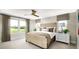 Cozy bedroom features large windows, neutral tones, and a ceiling fan at 614 Heritage Square Dr, Haines City, FL 33844