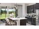 Well-equipped kitchen with sleek countertops, stainless steel appliances, and island seating area at 614 Heritage Square Dr, Haines City, FL 33844