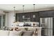 Stylish kitchen features modern appliances, an island with seating, and elegant pendant lighting at 614 Heritage Square Dr, Haines City, FL 33844