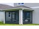 Enclosed screened porch with seating and an outdoor ceiling fan at 614 Heritage Square Dr, Haines City, FL 33844