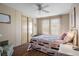 Well lit bedroom with wood look floors, closet, and an interior view of the sliding glass windows at 6711 Canterbury Ne Dr, Winter Haven, FL 33881