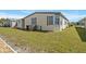 Side view of home, showing lawn, garden bed and windows at 6711 Canterbury Ne Dr, Winter Haven, FL 33881