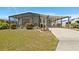 Charming home exterior with a well-maintained lawn and cozy screened porch at 6711 Canterbury Ne Dr, Winter Haven, FL 33881