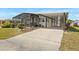 Charming home featuring a screened-in porch and a covered carport at 6711 Canterbury Ne Dr, Winter Haven, FL 33881