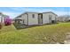 Side view of the property showcasing the well-maintained lawn and covered porch at 6711 Canterbury Ne Dr, Winter Haven, FL 33881