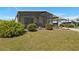Back yard view of the home, highlighting the screened porch and carport at 6711 Canterbury Ne Dr, Winter Haven, FL 33881