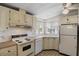 Efficient kitchen with classic appliances, lots of counter space and plenty of natural light at 6711 Canterbury Ne Dr, Winter Haven, FL 33881