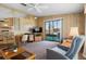 Comfortable living room featuring a sliding glass door and an adjoining kitchen at 6711 Canterbury Ne Dr, Winter Haven, FL 33881