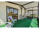 Relaxing screened patio with cozy furniture, providing an ideal space for outdoor living and entertaining at 6711 Canterbury Ne Dr, Winter Haven, FL 33881