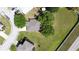 An aerial view of a home with a large yard, mature trees, and proximity to a main road at 7316 Hunters Greene Cir, Lakeland, FL 33810