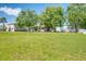 View of a house exterior with a large backyard and mature trees at 7316 Hunters Greene Cir, Lakeland, FL 33810