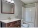 Updated bathroom featuring a vanity with a dark wood finish and a shower-tub combo at 7316 Hunters Greene Cir, Lakeland, FL 33810