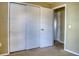 A bedroom featuring a closet with sliding doors and an open doorway at 7316 Hunters Greene Cir, Lakeland, FL 33810