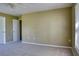 Spacious carpeted bedroom with ceiling fan and two windows, and three different doors at 7316 Hunters Greene Cir, Lakeland, FL 33810