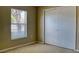 Bedroom with a window with blinds, carpeted flooring, and a closet with sliding doors at 7316 Hunters Greene Cir, Lakeland, FL 33810