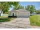 Charming single-story home with a well-maintained lawn and attached two-car garage at 7316 Hunters Greene Cir, Lakeland, FL 33810
