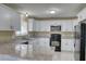 A kitchen featuring white cabinets, granite countertops and stainless steel appliances is displayed at 7316 Hunters Greene Cir, Lakeland, FL 33810