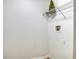 This is a laundry room with a wire shelf above the washer dryer hookups and a decorative Christmas tree at 7316 Hunters Greene Cir, Lakeland, FL 33810