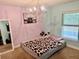 Bedroom with carpet floors, chandelier, and lilac and teal walls at 74 N Oak Ave, Umatilla, FL 32784