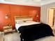 Bright bedroom with a wood accent wall, stylish decor, and ample natural light at 74 N Oak Ave, Umatilla, FL 32784