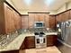 Well-equipped kitchen with granite countertops, stainless steel appliances, and backsplash at 74 N Oak Ave, Umatilla, FL 32784