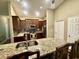 Well-equipped kitchen with granite countertops, stainless steel appliances, and a breakfast bar at 74 N Oak Ave, Umatilla, FL 32784