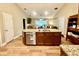 Open kitchen with a large center island, modern appliances, and wood plank flooring at 74 N Oak Ave, Umatilla, FL 32784