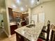 Well-equipped kitchen with granite countertops, stainless steel appliances, and a center island at 74 N Oak Ave, Umatilla, FL 32784