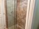 Walk-in shower featuring glass door, tiled surround and floor, and chrome hardware at 74 N Oak Ave, Umatilla, FL 32784