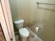 Small water closet featuring standard toilet, towel bar, and tile flooring at 74 N Oak Ave, Umatilla, FL 32784