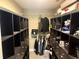 Large walk-in closet with dark wood shelving and ample storage space at 74 N Oak Ave, Umatilla, FL 32784