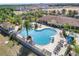 A serene view of the community pool with palm trees and lounge chairs for relaxation at 7526 Pellham Way, Kissimmee, FL 34747