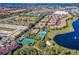 This aerial view features a lake, pool, and tennis court enhancing the desirable community atmosphere at 7526 Pellham Way, Kissimmee, FL 34747