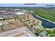 Wide aerial shot of a community with a lake, amenities, and distant views of Downtown Orlando and Disney World at 7526 Pellham Way, Kissimmee, FL 34747